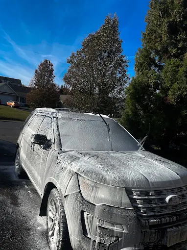 Ford Explorer covered in thick snow foam during a wash by Constable Car Detailing in Harrisonburg, Virginia